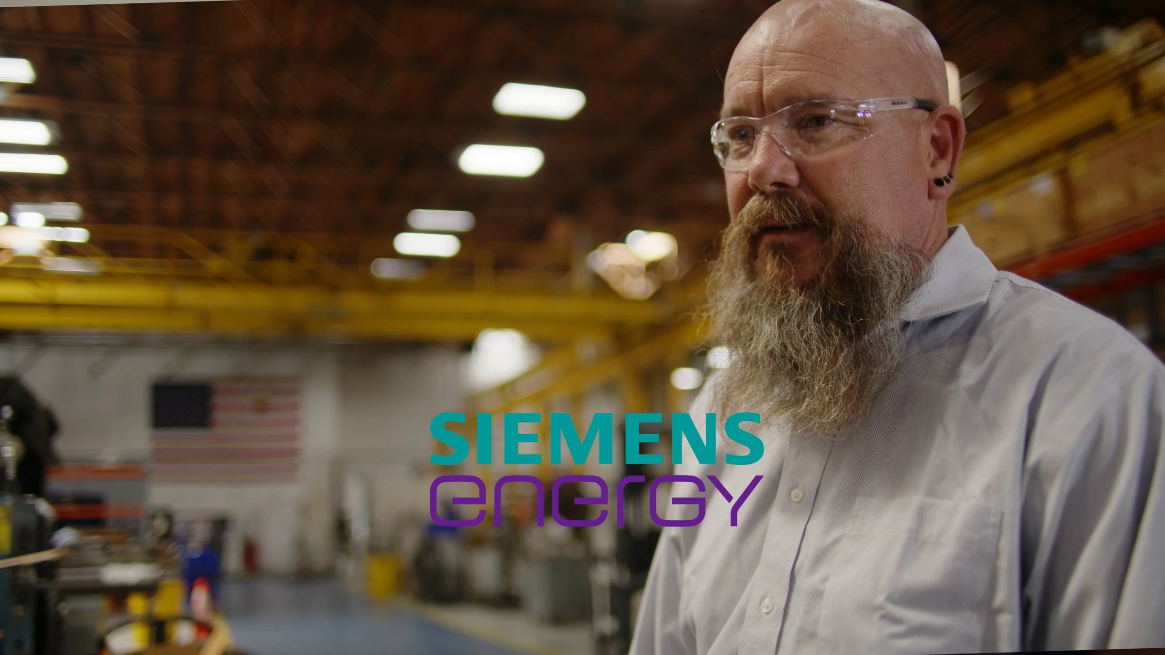 Engineer speaking inside Siemens Energy manufacturing facility