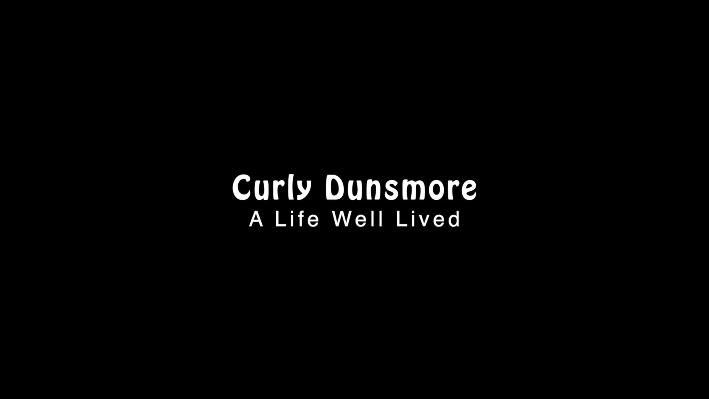 Curly Dunsmore memorial title card with the words “A Life Well Lived” on a black background.