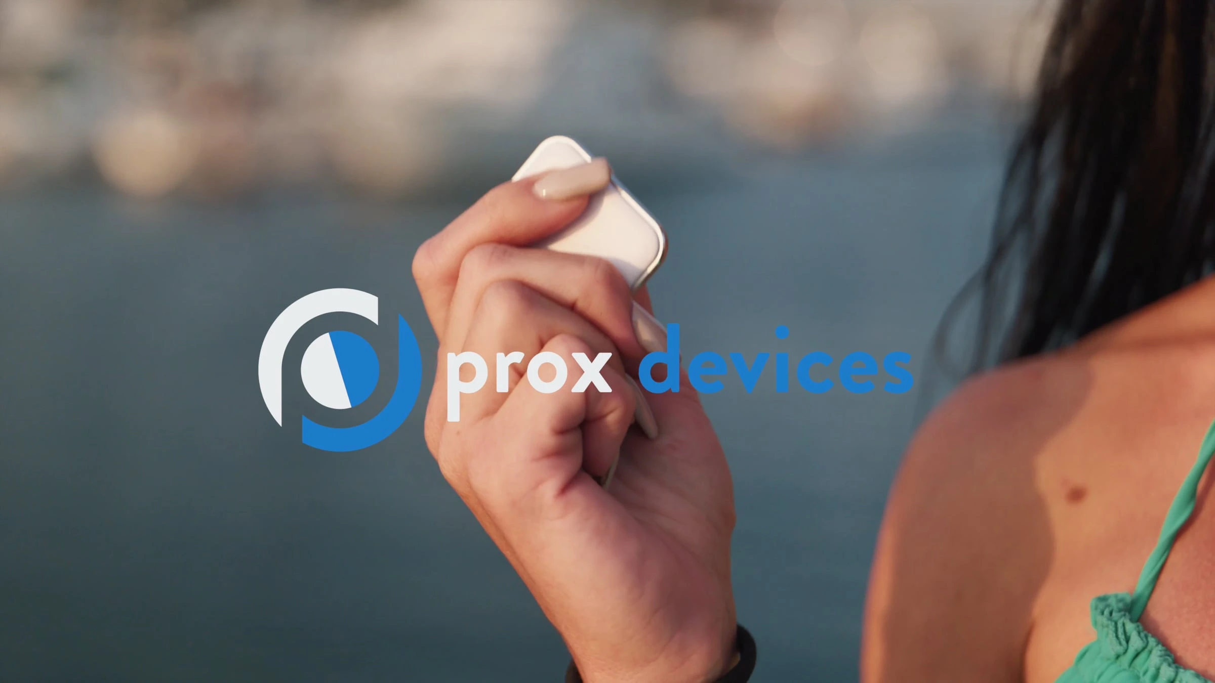 Person holding a smartphone with Prox Devices branding